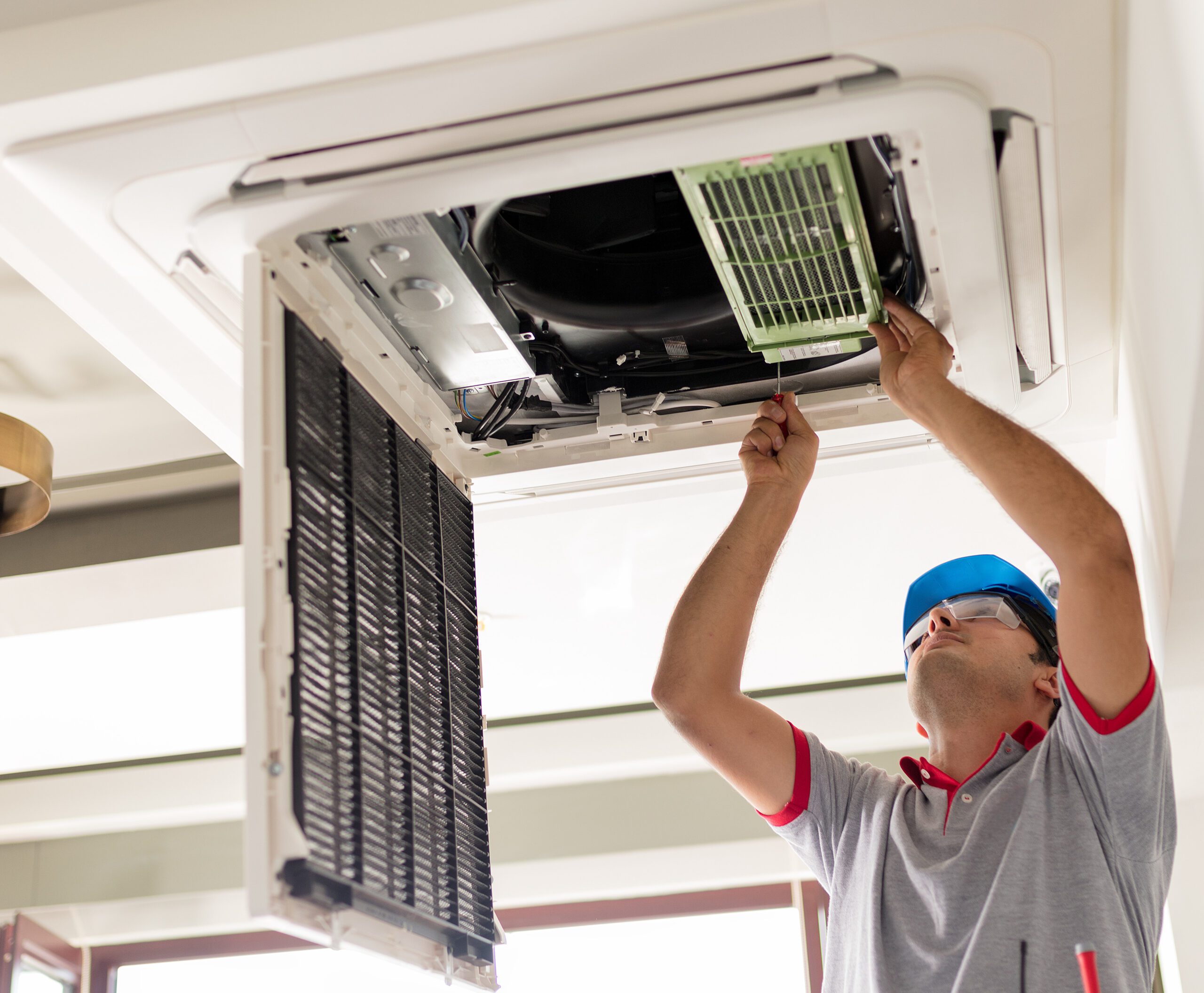 HVAC contractor working on A/C unit