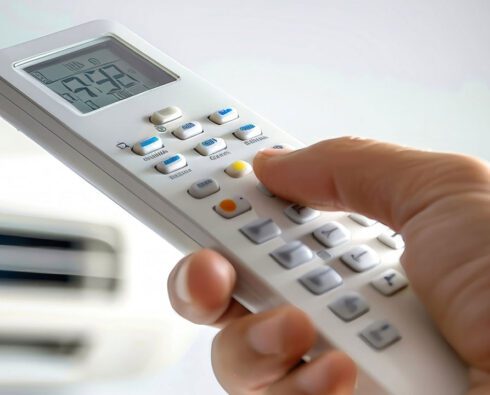 Hand holding smart HVAC remote control